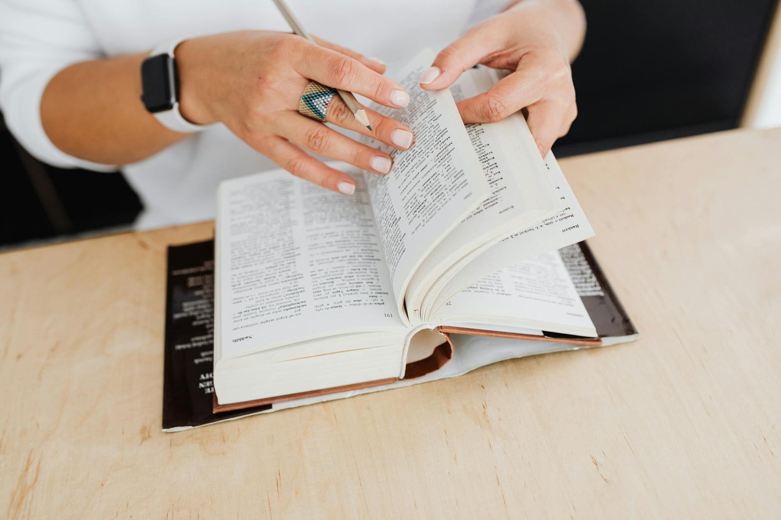 close up of woman flicking the pages of a book